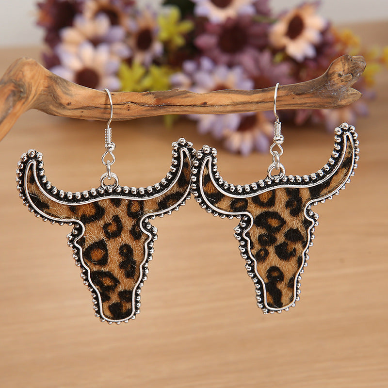 Leopard print cow skull shaped earrings