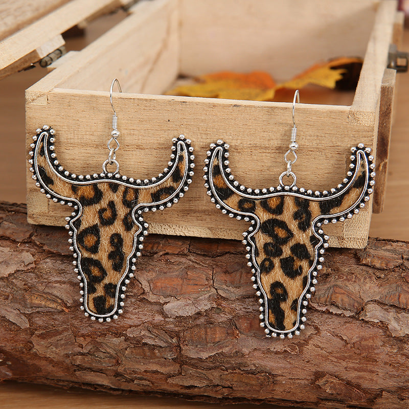 Leopard print cow skull shaped earrings
